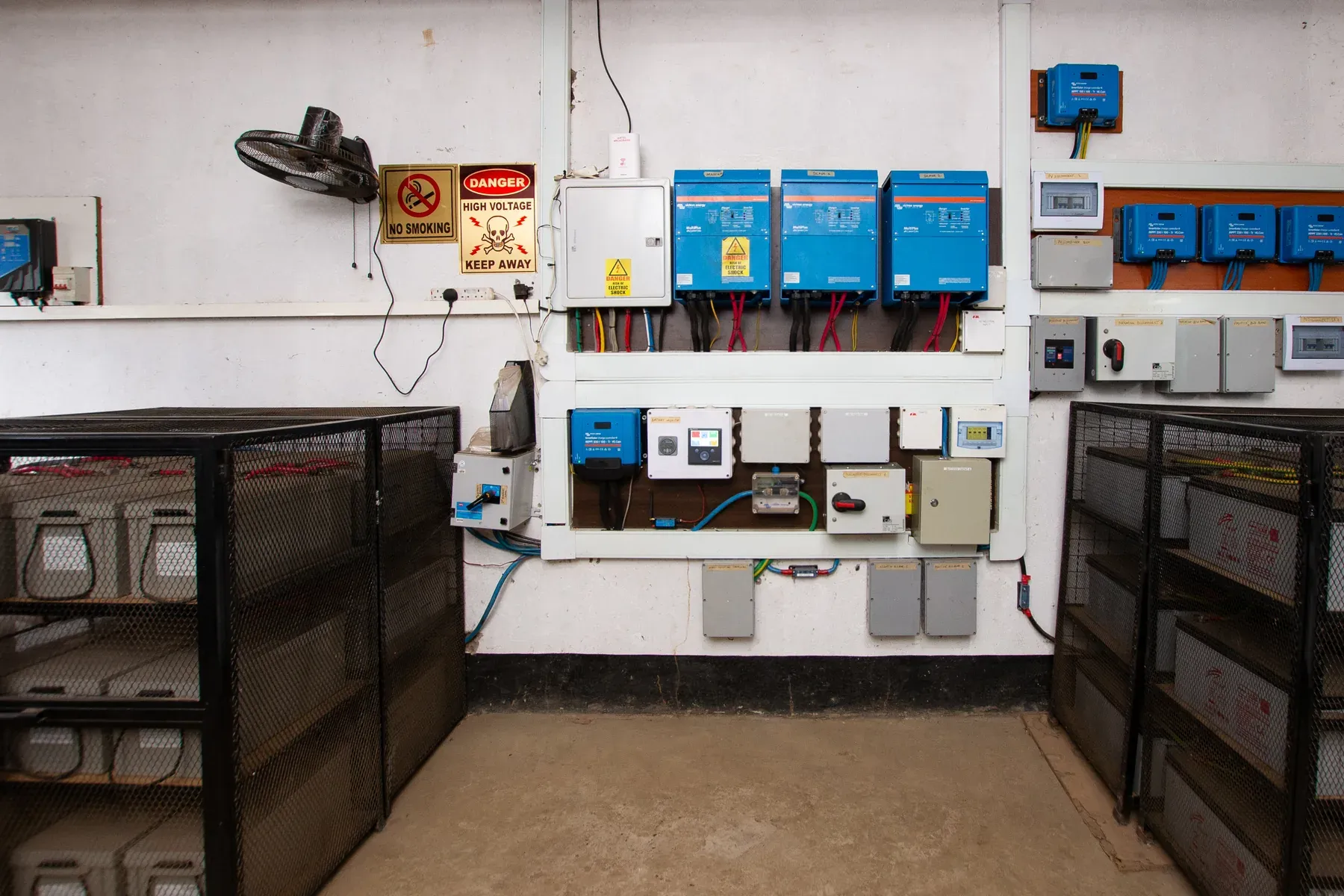 The control room at the mini grid, with inverters, meters and battery enclosures
