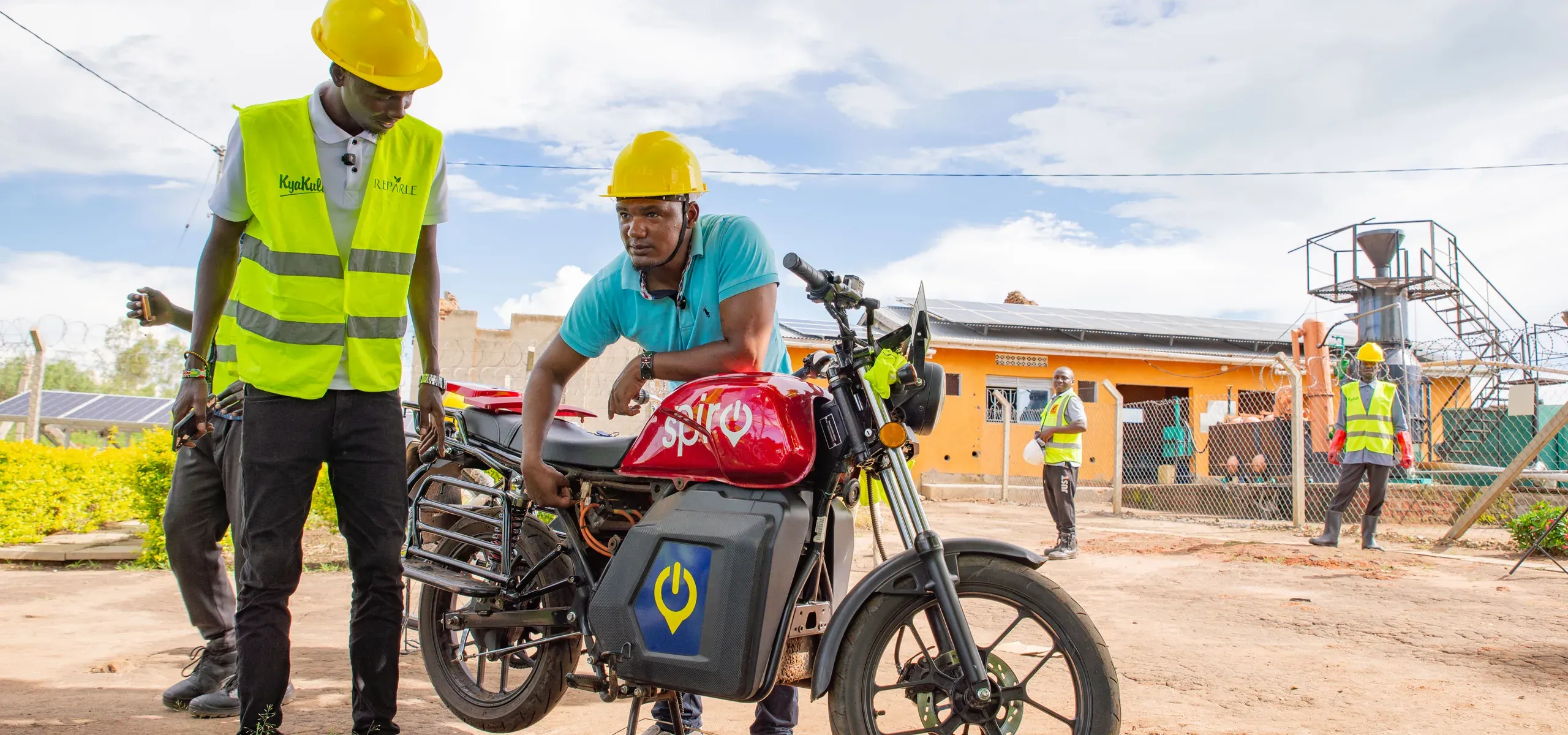 A rider and a project worker with an electric motorcycle at the Got Ngur site