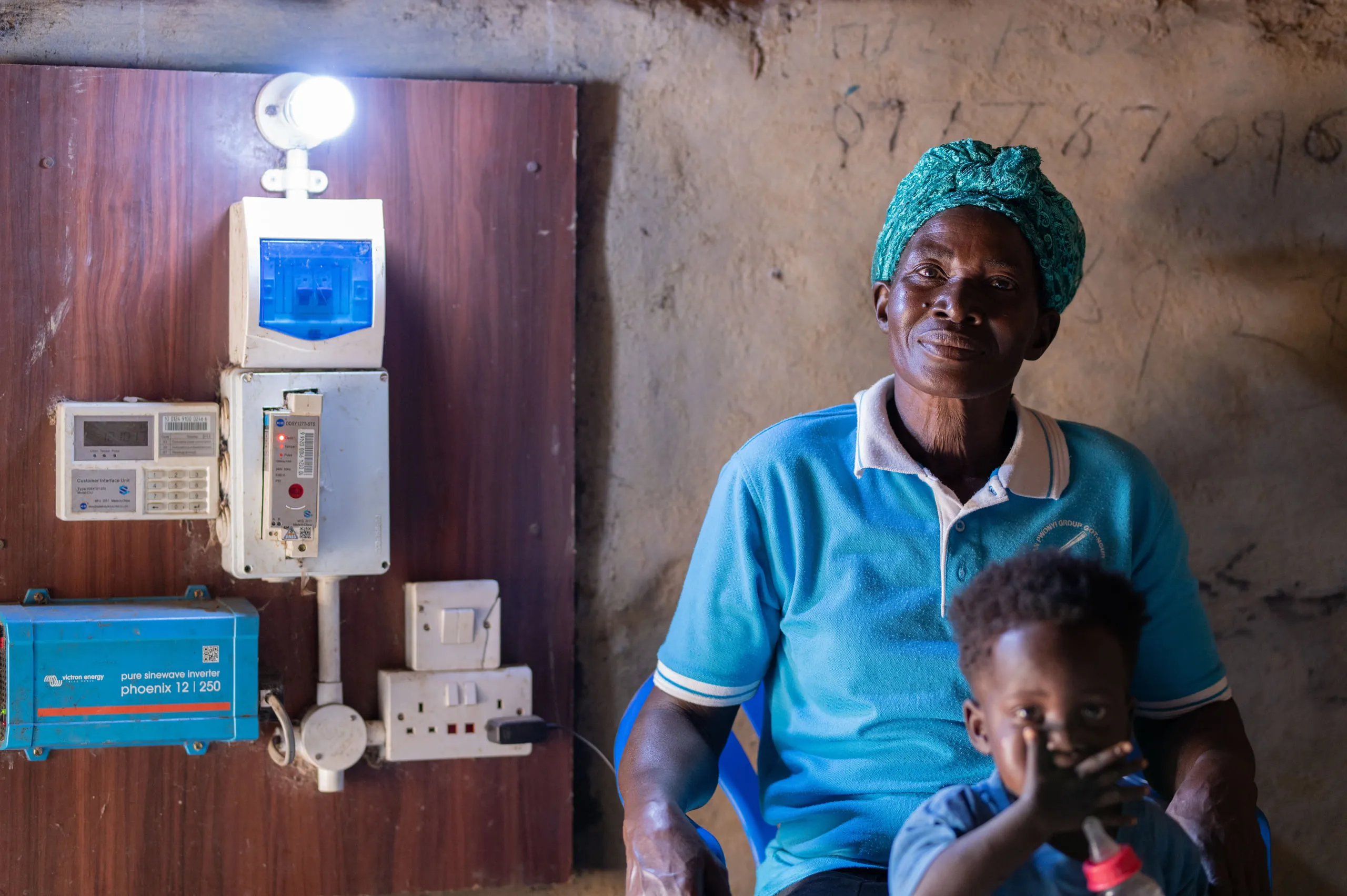 A customer and child beside their metered connection