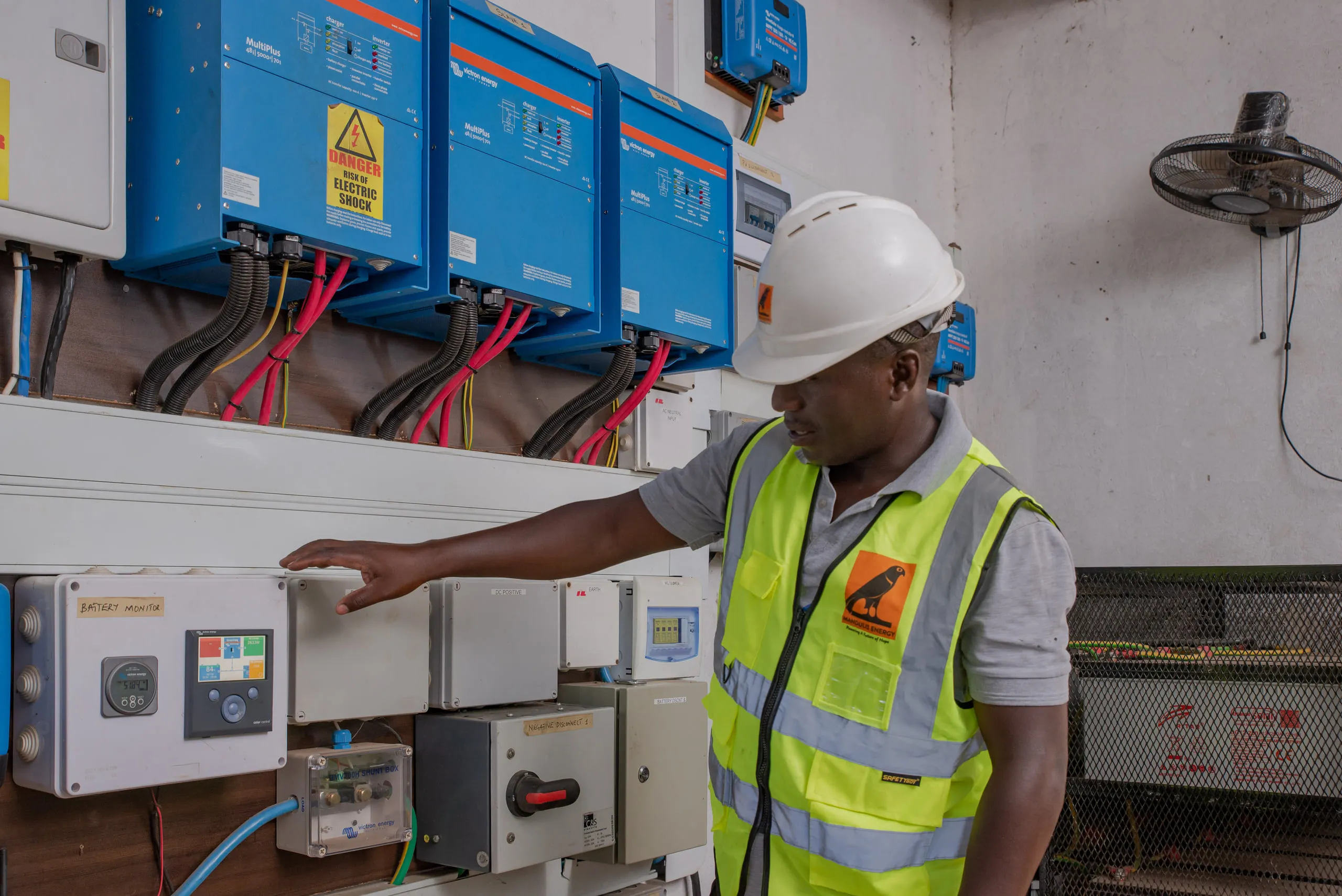 An operator checking inverter and control equipment