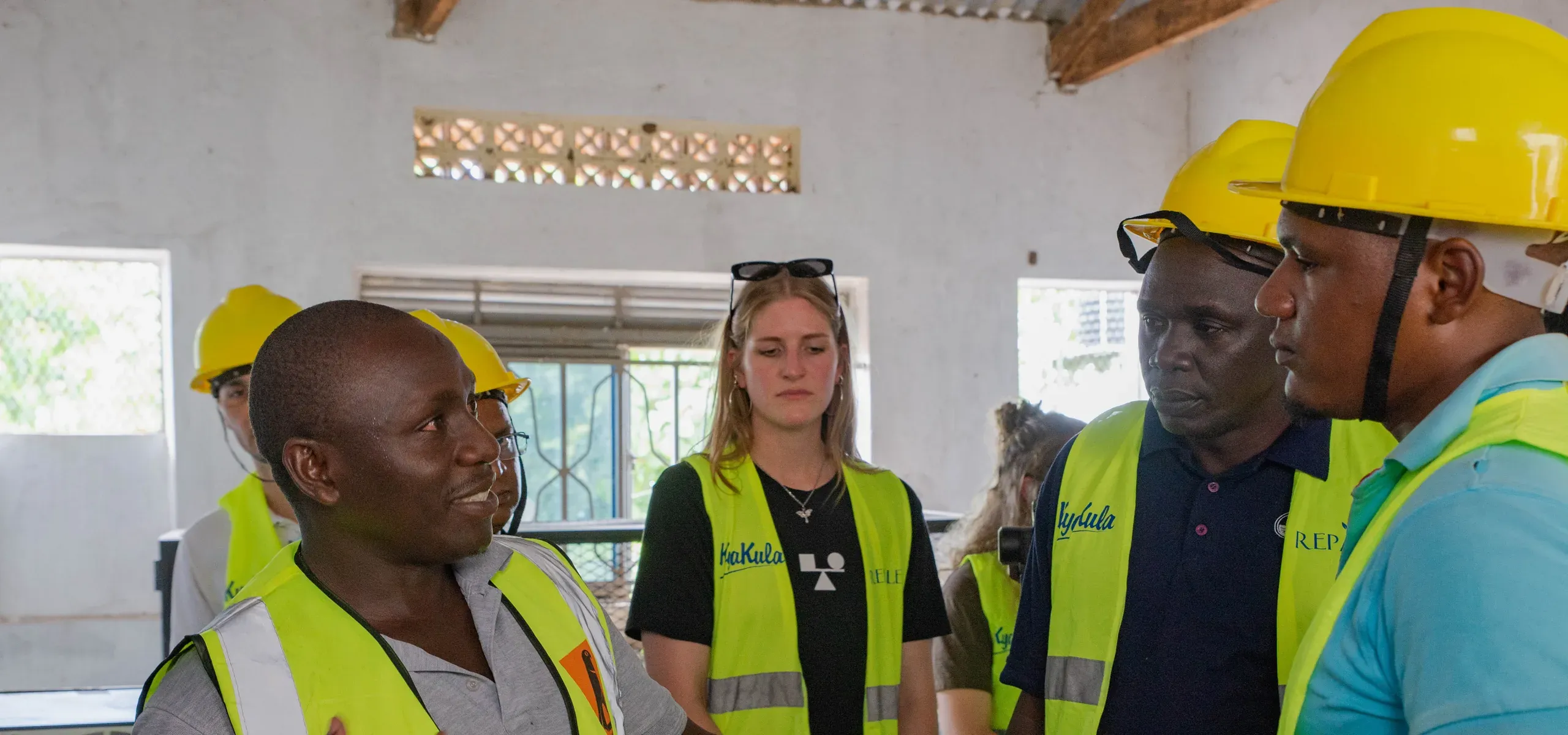 A project engineer briefing visitors inside the site building at Got Ngur