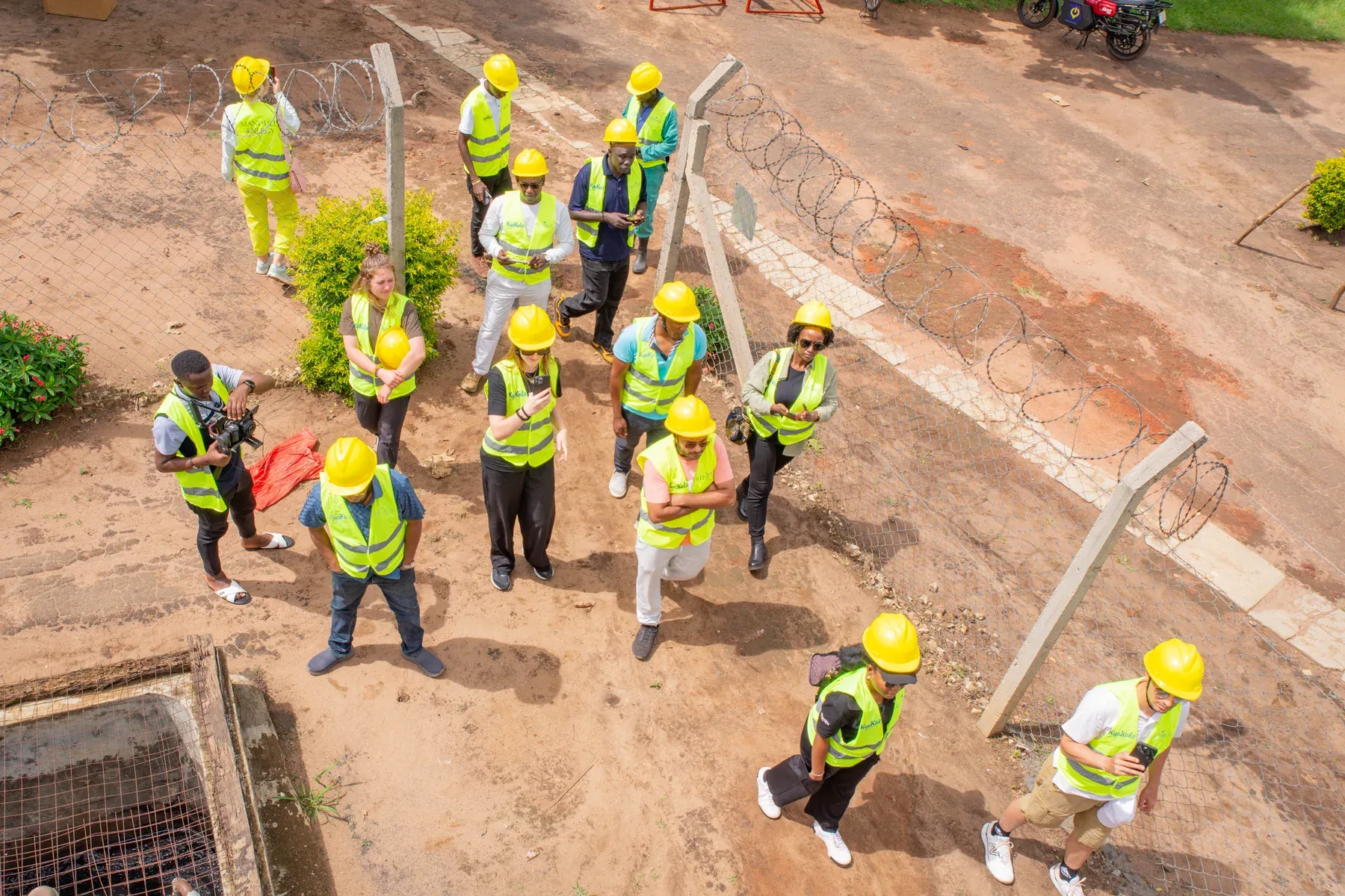An overhead view of the project team in high-visibility vests walking across the site